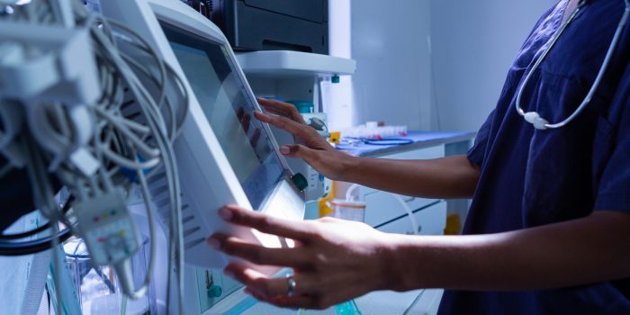 Surgeon using medical equipment in operating room of the hospita